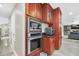Well-equipped kitchen with built-in wall oven, microwave, and extra storage at 7920 Summer Ridge Pl, Orlando, FL 32819