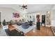 Bright and inviting living room with hardwood floors, comfortable seating, and large windows at 7920 Summer Ridge Pl, Orlando, FL 32819