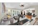 Open and airy living area with hardwood floors, comfortable seating, and a view of the pool at 7920 Summer Ridge Pl, Orlando, FL 32819
