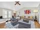 Spacious living room with hardwood floors, comfortable seating, and a view of the backyard at 7920 Summer Ridge Pl, Orlando, FL 32819