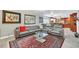 Open living room with sectional sofa, large windows, and view of kitchen at 7920 Summer Ridge Pl, Orlando, FL 32819