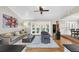 Spacious living room with hardwood floors, comfortable seating, and access to the backyard at 7920 Summer Ridge Pl, Orlando, FL 32819