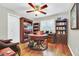 Home office with built-in bookcases, hardwood floors, and a large desk at 7920 Summer Ridge Pl, Orlando, FL 32819
