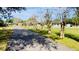Long tree-lined driveway leading to the house at 6747 Whispering Pines Rd, Orlando, FL 32824