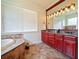 Elegant Primary bathroom with double vanity and large mirror at 1217 Radiant St, Reunion, FL 34747