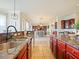 Spacious kitchen with an island, granite countertops, and views into the Gathering room at 1217 Radiant St, Reunion, FL 34747
