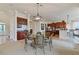 Bright dining room features a glass-top table and comfortable seating for six at 1217 Radiant St, Reunion, FL 34747