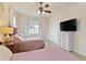 Guest bedroom with two twin beds and ceiling fan at 1217 Radiant St, Reunion, FL 34747
