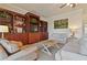 Living room with built-in shelving and comfortable seating at 1217 Radiant St, Reunion, FL 34747