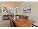 Bright dining room with a large table, chandelier, and views to the entryway and kitchen at 1217 Radiant St, Reunion, FL 34747