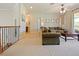 Bonus room features a sectional sofa, coffee table, and access to a balcony at 1217 Radiant St, Reunion, FL 34747