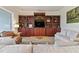 Living room with built-in shelving and comfortable seating at 1217 Radiant St, Reunion, FL 34747