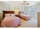 Guest bedroom with two twin beds and ceiling fan at 1217 Radiant St, Reunion, FL 34747