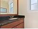 Bathroom with dark vanity and granite countertop at 1217 Radiant St, Reunion, FL 34747