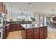 Open kitchen with large island, granite counters, stainless steel appliances, and breakfast nook at 1217 Radiant St, Reunion, FL 34747