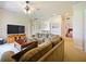 Bright bonus room includes a sectional sofa and large TV at 1217 Radiant St, Reunion, FL 34747