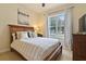 Cozy bedroom with a large window and wood furniture at 1217 Radiant St, Reunion, FL 34747