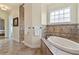 Relaxing bathroom with soaking tub, shower, and tile flooring at 1217 Radiant St, Reunion, FL 34747