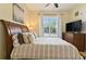 Bedroom with large window and wood furniture at 1217 Radiant St, Reunion, FL 34747