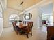 Formal dining room with a large wooden table, chandelier, and hardwood floors at 1217 Radiant St, Reunion, FL 34747