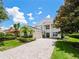 Two-story home with a paver driveway and landscaping at 1217 Radiant St, Reunion, FL 34747