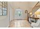 Inviting entryway with a large front door, tiled floor, and a console table with lamps at 1217 Radiant St, Reunion, FL 34747