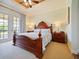 Spacious Primary bedroom with a large bed and access to a private balcony at 1217 Radiant St, Reunion, FL 34747
