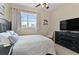 Bright bedroom with queen bed, TV, and ample closet space at 1217 Radiant St, Reunion, FL 34747