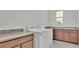 Bright laundry room with washer, dryer, and ample counter space at 2686 Meadowedge Loop, Saint Cloud, FL 34772