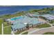 Community clubhouse with adjacent pool and lake views at 2686 Meadowedge Loop, Saint Cloud, FL 34772