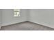 Bright bedroom with gray carpeting and window at 2686 Meadowedge Loop, Saint Cloud, FL 34772
