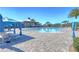 Resort-style pool with lounge chairs and blue umbrellas at 2686 Meadowedge Loop, Saint Cloud, FL 34772