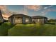 Private backyard with covered patio at sunset at 2686 Meadowedge Loop, Saint Cloud, FL 34772