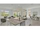 Kitchen island with granite countertop, sink and seating area at 2686 Meadowedge Loop, Saint Cloud, FL 34772