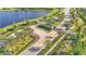 Community entrance with palm trees and a lake in the background at 2686 Meadowedge Loop, Saint Cloud, FL 34772