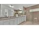 Elegant bathroom with double vanity, granite countertop, and large walk-in shower at 2686 Meadowedge Loop, Saint Cloud, FL 34772