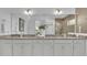 Bathroom featuring double vanity, granite countertops, and large mirror at 2686 Meadowedge Loop, Saint Cloud, FL 34772