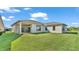 Spacious backyard with grassy lawn and covered patio at 2686 Meadowedge Loop, Saint Cloud, FL 34772