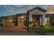 House exterior at dusk with a two car garage at 2686 Meadowedge Loop, Saint Cloud, FL 34772