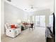 Bright living room featuring comfortable seating, a large TV, and sliding doors leading to a patio at 153 Marabella Loop, Poinciana, FL 34759