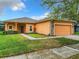 House exterior with a brick walkway and attached garage at 153 Marabella Loop, Poinciana, FL 34759