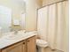 Clean bathroom with a shower/tub combo and wood vanity at 153 Marabella Loop, Poinciana, FL 34759