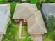 Housetop view of a single Gathering home with a brick walkway and well maintained lawn at 153 Marabella Loop, Poinciana, FL 34759
