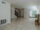 Living room with tile floors, fireplace and stairs to upper level at 824 Park Lake Pl # 824, Maitland, FL 32751