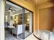 Glass door leads to a small balcony with table and chairs, overlooking a living area at 12539 Floridays Resort Dr 306D, Orlando, FL 32821