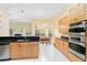 Modern kitchen with light wood cabinets, granite countertops and stainless steel appliances at 840 Coach Lamp Ct, Sanford, FL 32771