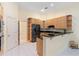 Kitchen with light wood cabinets, granite countertops, and stainless steel appliances at 840 Coach Lamp Ct, Sanford, FL 32771