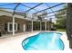 Relaxing kidney-shaped pool with screened enclosure and patio at 840 Coach Lamp Ct, Sanford, FL 32771
