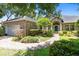 Brick home with a landscaped lawn, walkway, and attached garage at 840 Coach Lamp Ct, Sanford, FL 32771