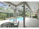 Inviting screened pool area with patio furniture and lush landscaping at 840 Coach Lamp Ct, Sanford, FL 32771